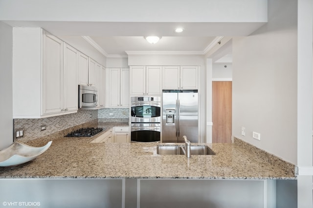 kitchen featuring kitchen peninsula, white cabinetry, sink, crown molding, and stainless steel appliances