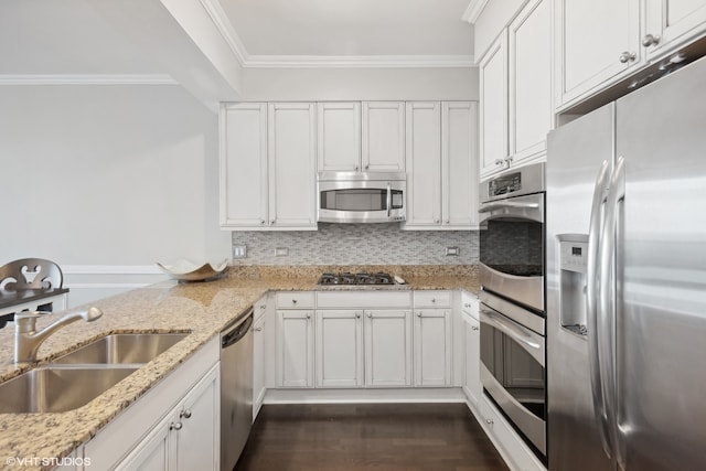 kitchen featuring dark hardwood / wood-style floors, stainless steel appliances, sink, white cabinets, and light stone counters