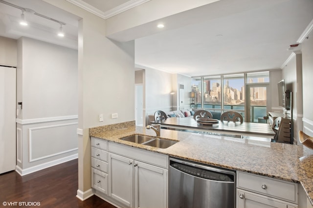 kitchen featuring crown molding, sink, stainless steel dishwasher, dark wood-type flooring, and light stone counters