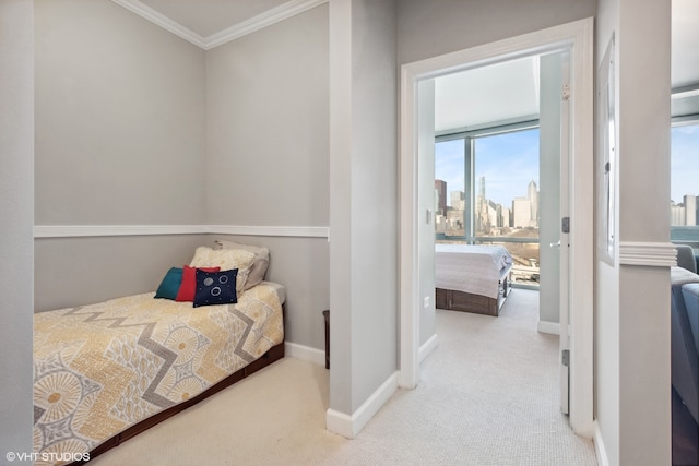 bedroom featuring crown molding and light carpet