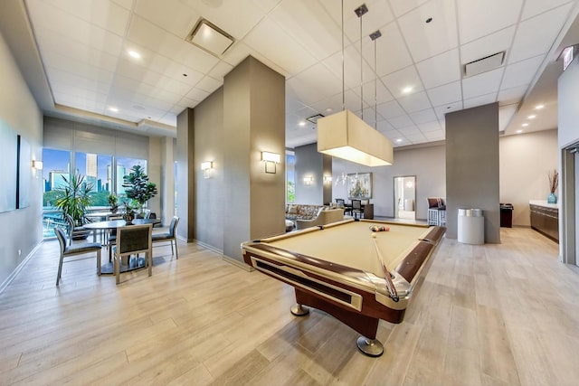 playroom with light wood-type flooring, billiards, and a paneled ceiling