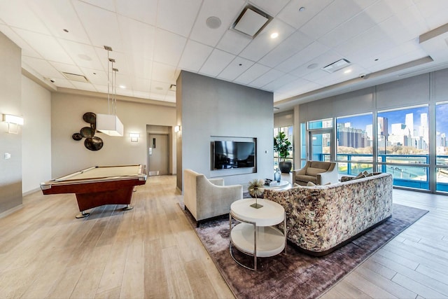 living room with light hardwood / wood-style floors and pool table