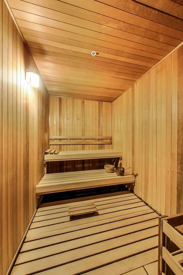 view of sauna with hardwood / wood-style flooring, wood walls, and wooden ceiling