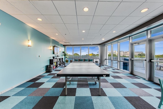 recreation room featuring dark carpet and plenty of natural light