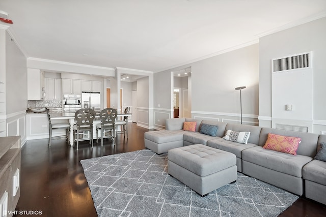 living room featuring crown molding and dark hardwood / wood-style floors