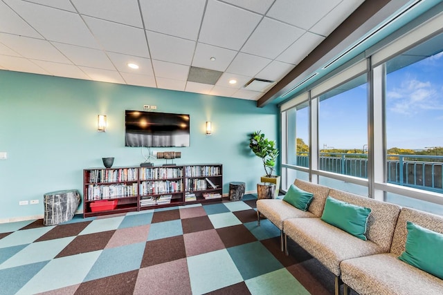 living room featuring a drop ceiling