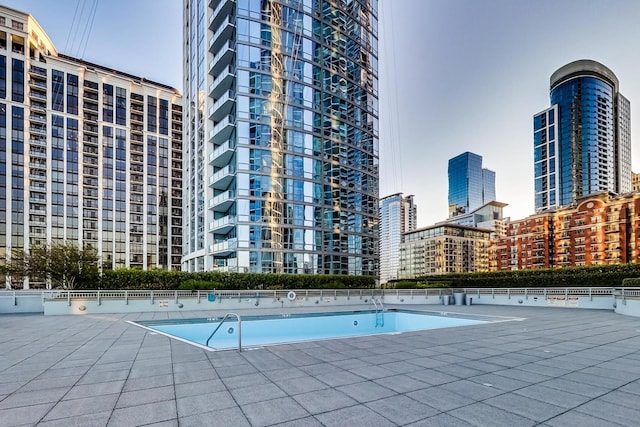 view of pool featuring tennis court