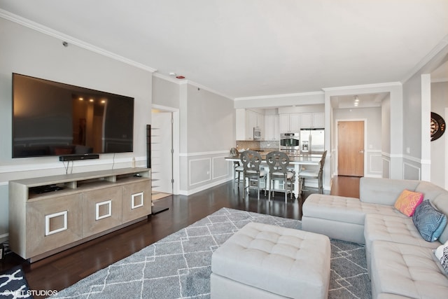 living room with crown molding and dark hardwood / wood-style flooring