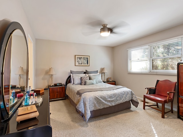 bedroom featuring ceiling fan and light carpet