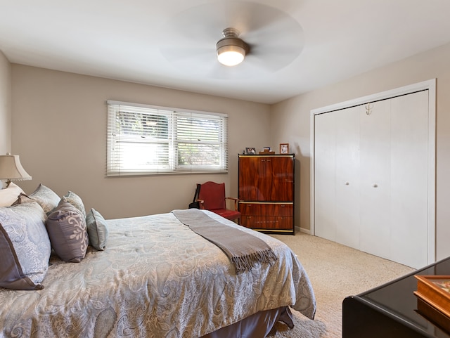 bedroom featuring ceiling fan, a closet, and light carpet