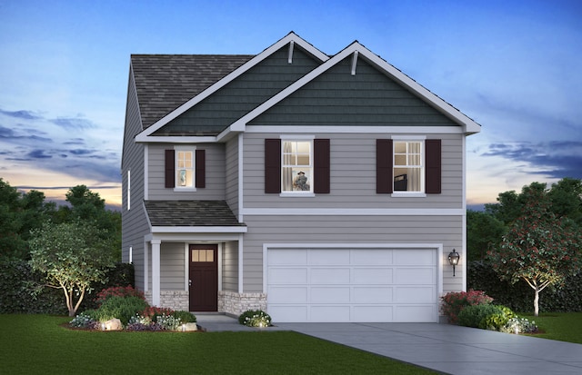 view of front facade with a yard and a garage