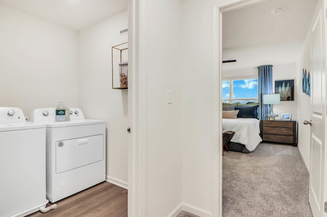 washroom with washer and dryer and light hardwood / wood-style floors