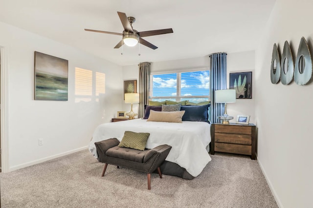 bedroom with ceiling fan and light colored carpet