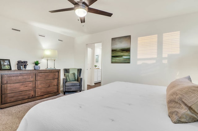 carpeted bedroom with ceiling fan and connected bathroom