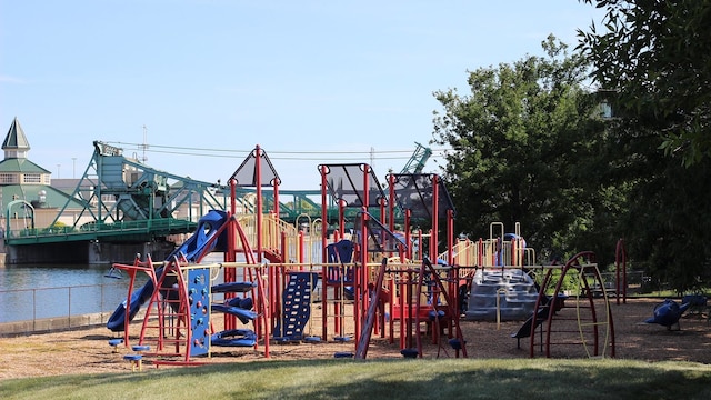 view of jungle gym featuring a water view