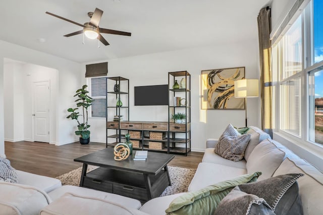 living room with ceiling fan, a healthy amount of sunlight, and dark wood-type flooring