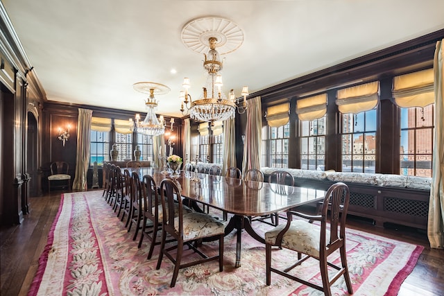 dining area with an inviting chandelier, crown molding, plenty of natural light, and dark hardwood / wood-style flooring