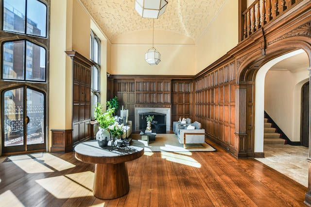 unfurnished room with high vaulted ceiling, ornamental molding, and dark hardwood / wood-style flooring