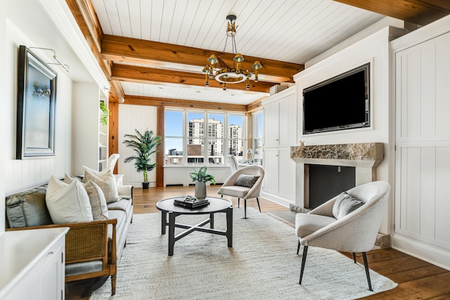 living room with light hardwood / wood-style floors, a premium fireplace, and beam ceiling