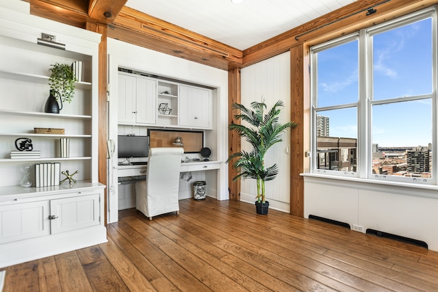 office with built in desk and hardwood / wood-style flooring