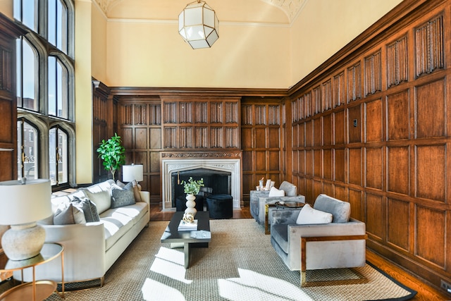 living room with ornamental molding, hardwood / wood-style flooring, and a high ceiling