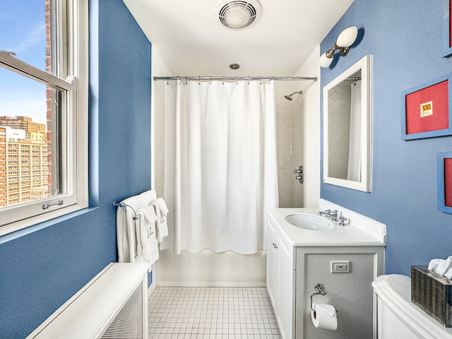 full bathroom featuring toilet, radiator, tile patterned flooring, shower / tub combo, and vanity