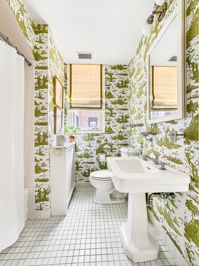 bathroom featuring tile patterned floors and toilet