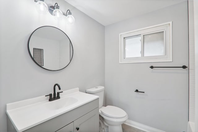 bathroom featuring toilet and vanity