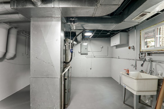 basement with electric panel and sink