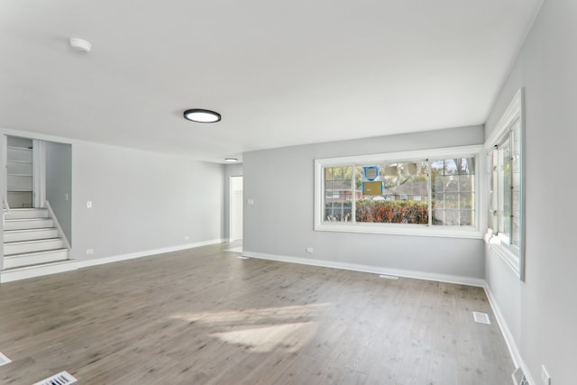 unfurnished living room with wood-type flooring