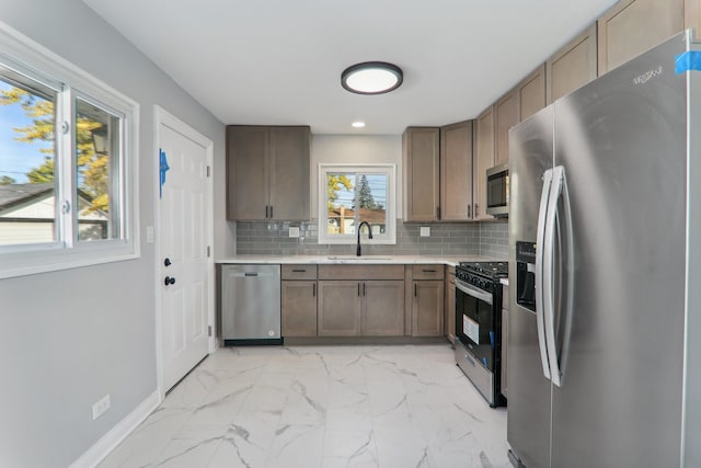 kitchen featuring sink, appliances with stainless steel finishes, and backsplash