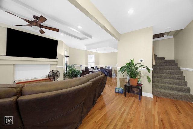 living room with beamed ceiling, ceiling fan, and light hardwood / wood-style flooring