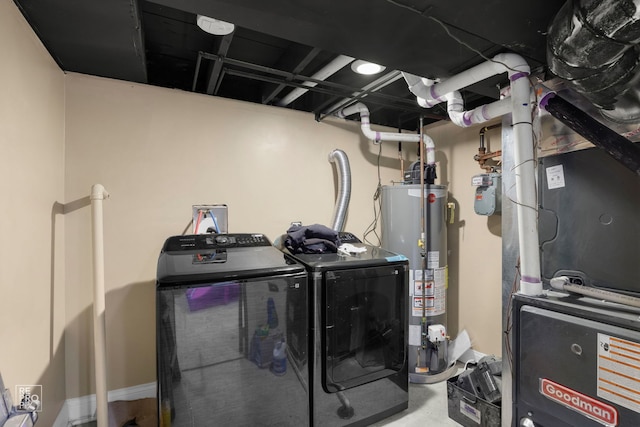 laundry area featuring heating unit, gas water heater, and separate washer and dryer