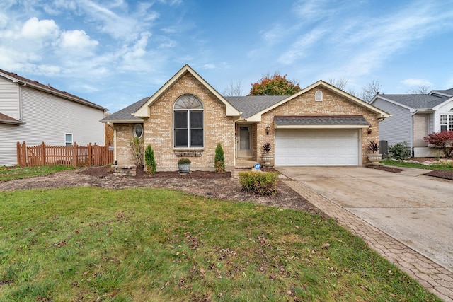 view of front of home featuring a garage and a front yard