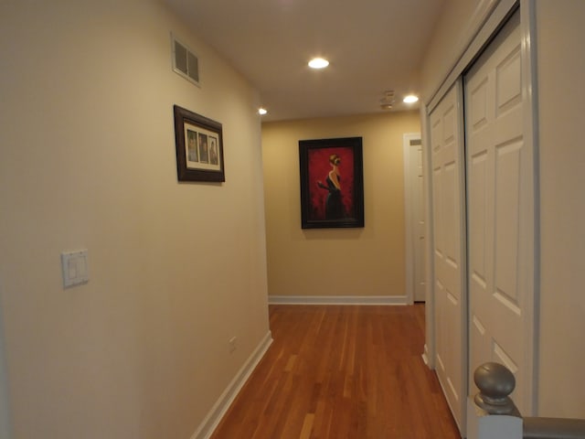 hallway with hardwood / wood-style flooring