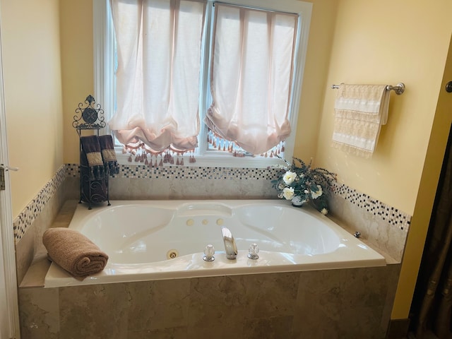 bathroom featuring tiled tub