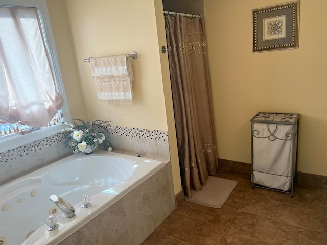 bathroom featuring tile patterned floors and separate shower and tub