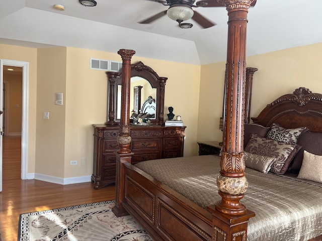 bedroom featuring lofted ceiling, hardwood / wood-style flooring, and ceiling fan