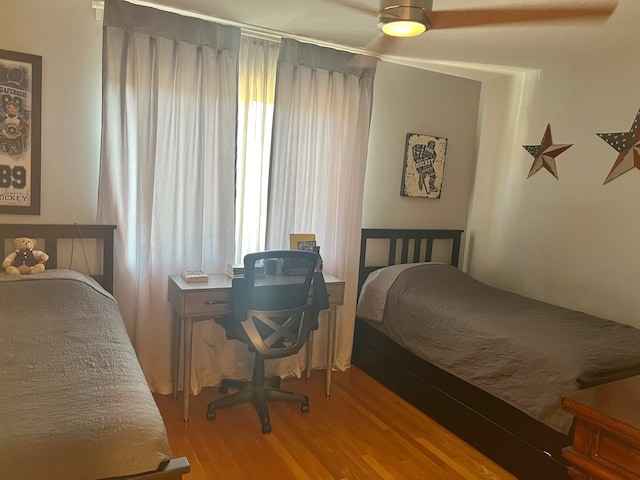 bedroom featuring hardwood / wood-style floors and ceiling fan