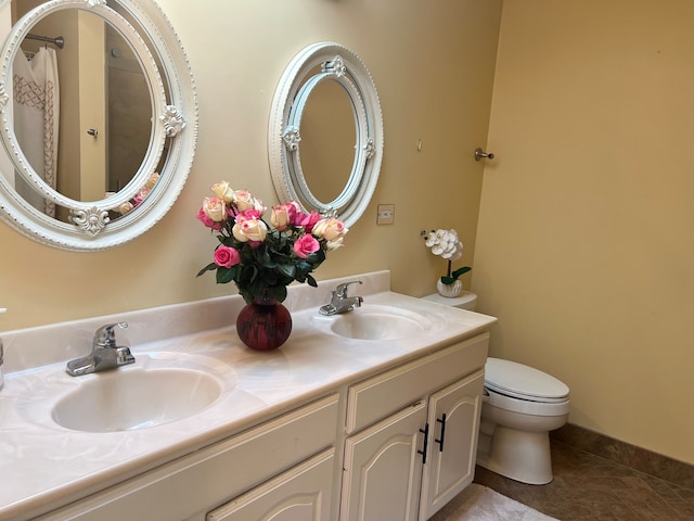 bathroom with vanity, toilet, and tile patterned flooring