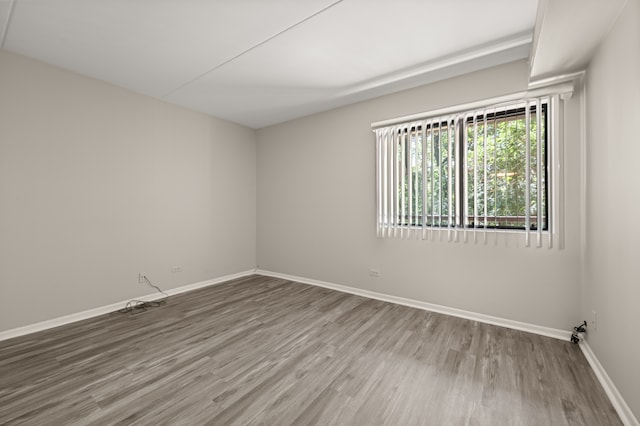 empty room with hardwood / wood-style floors