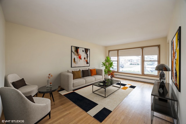 living room featuring a baseboard radiator and light hardwood / wood-style floors