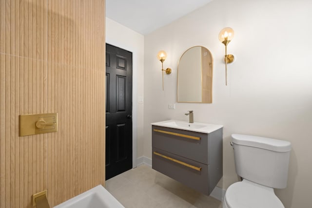 bathroom featuring tile patterned flooring, vanity, and toilet