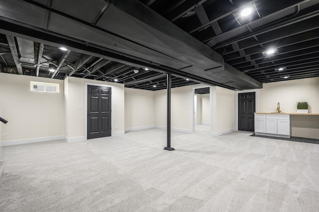 basement featuring light colored carpet and bar