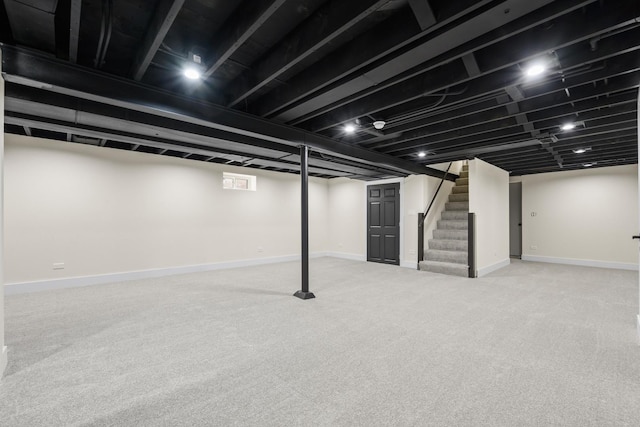 basement featuring light carpet