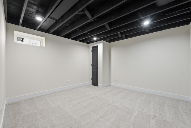 basement featuring light carpet