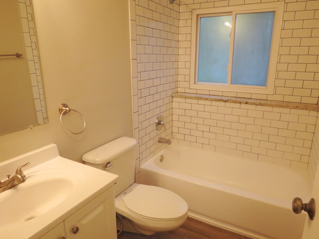 full bathroom with vanity, toilet, hardwood / wood-style floors, and tiled shower / bath