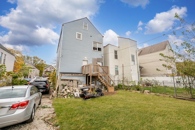 rear view of property with a yard and a wooden deck