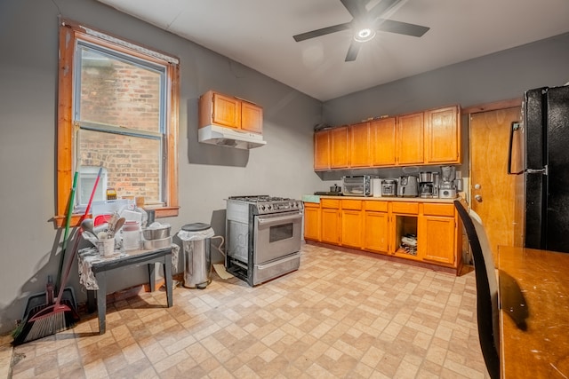 kitchen with black fridge, ceiling fan, and stainless steel gas range