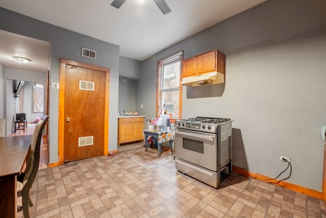 kitchen with stainless steel gas stove and ceiling fan